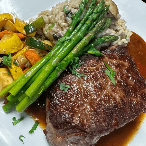 Ribeye with mushroom risotto and roasted vegetables