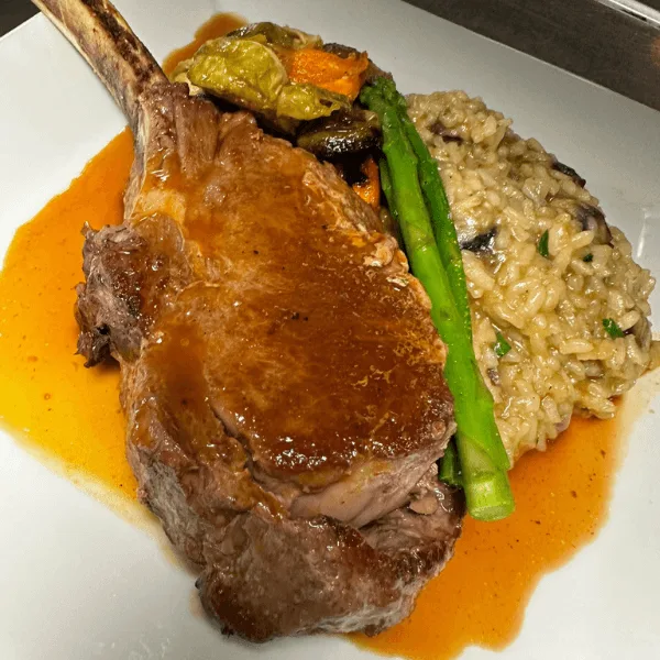 Veal chop with mushroom risotto and roasted vegetables