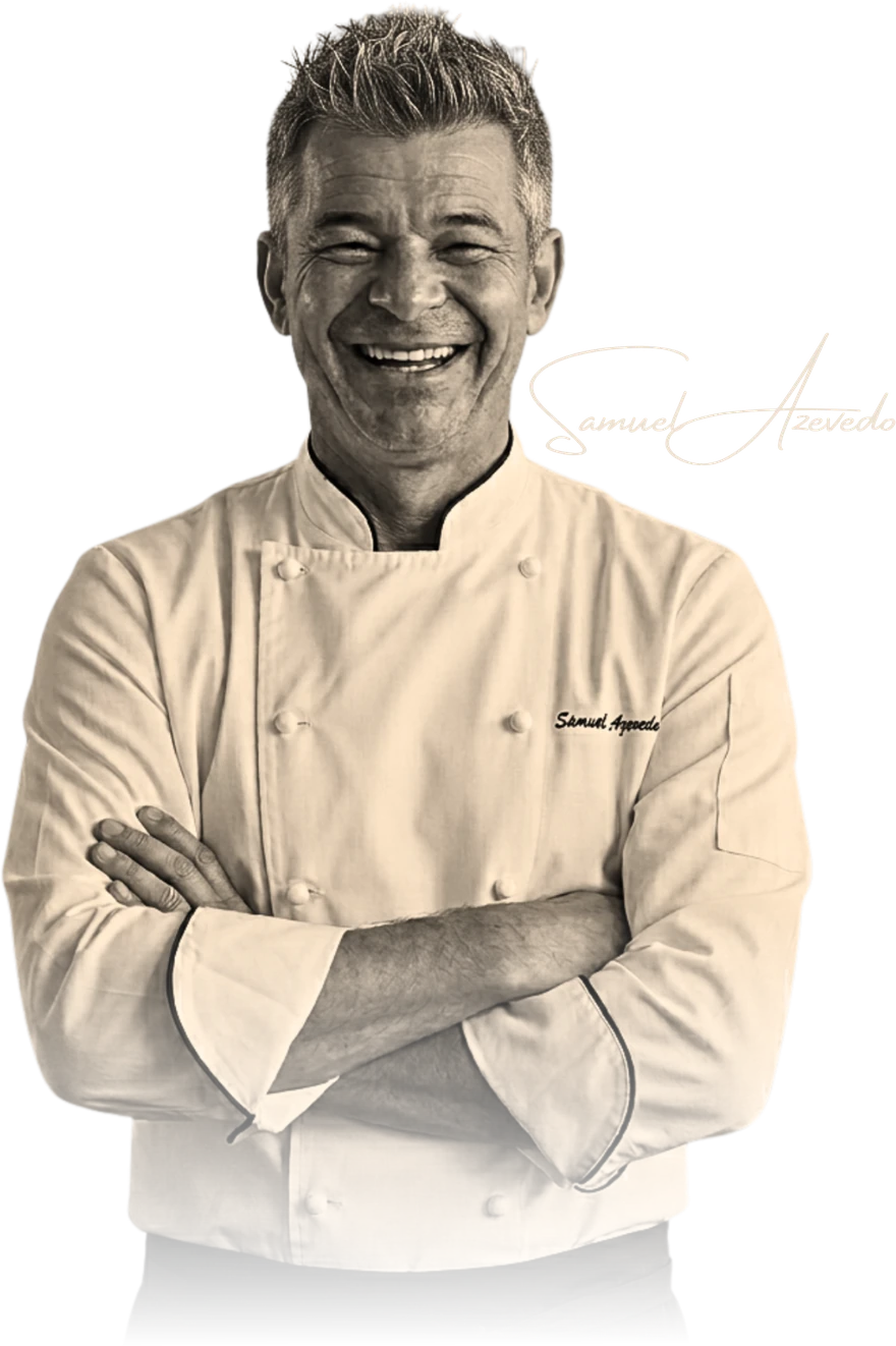 Chef Samuel Azevedo in his chef’s whites, arms crossed, with his signature alongside